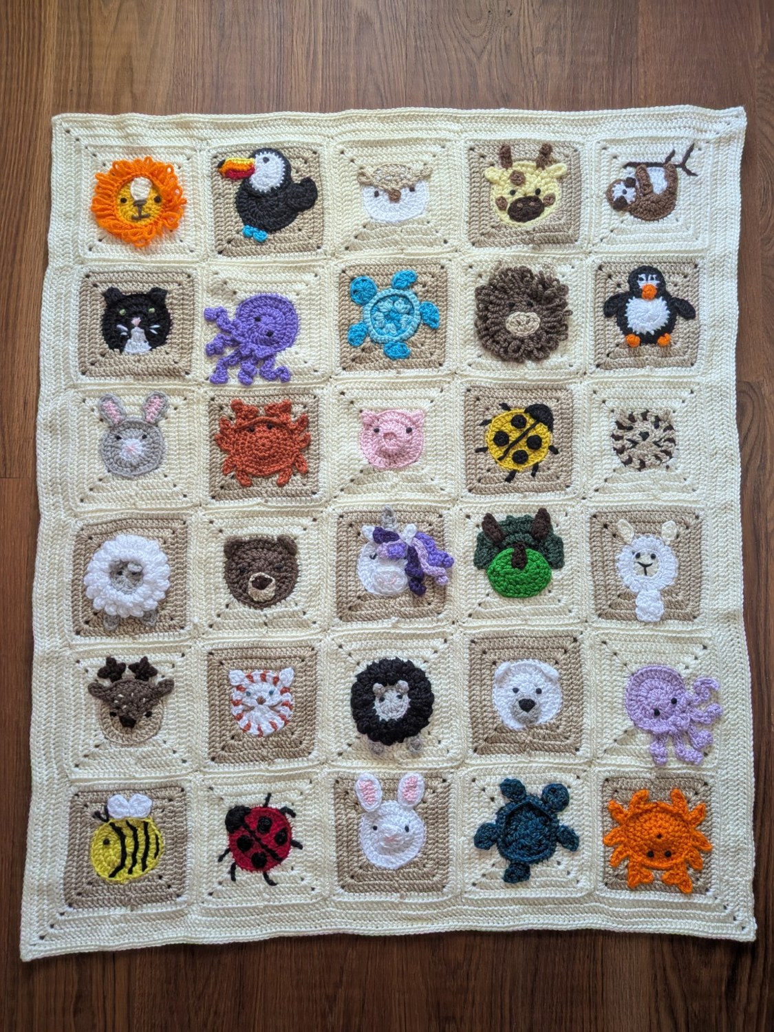 Handmade blanket with colorful crocheted animal squares