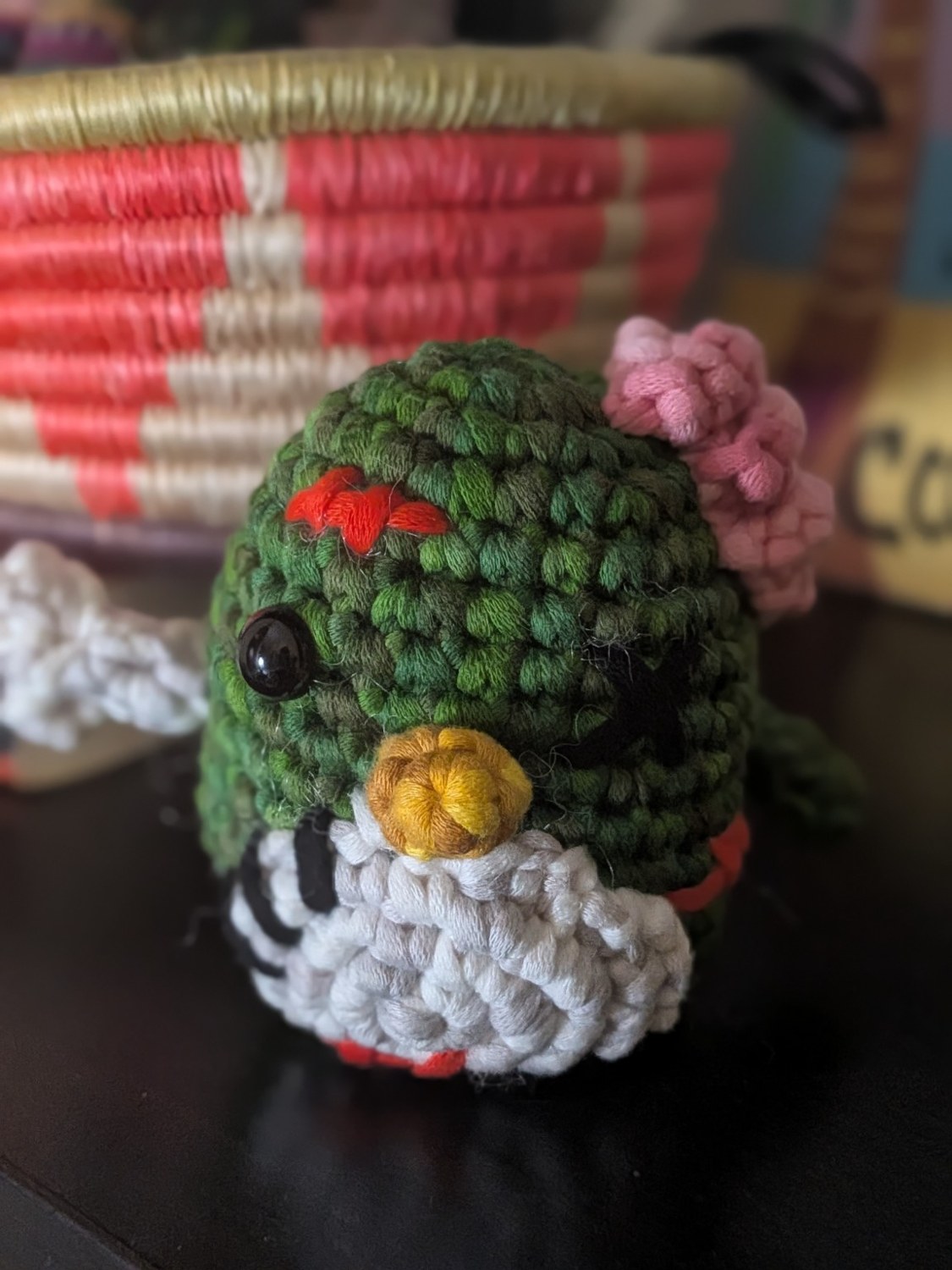 Monster Pierre, a green crochet penguin with a pink exposed brain and stitched details
